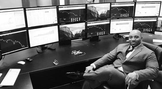 Anthony Deveaux at his trading desk with 12 monitors